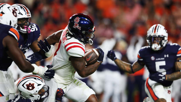 Oct 21, 2023; Auburn, Alabama, USA; Auburn defenders try to tackle Mississippi Rebels running back Quinshon Judkins (4) during the second quarter at Jordan-Hare Stadium. Mandatory Credit: John Reed-USA TODAY Sports